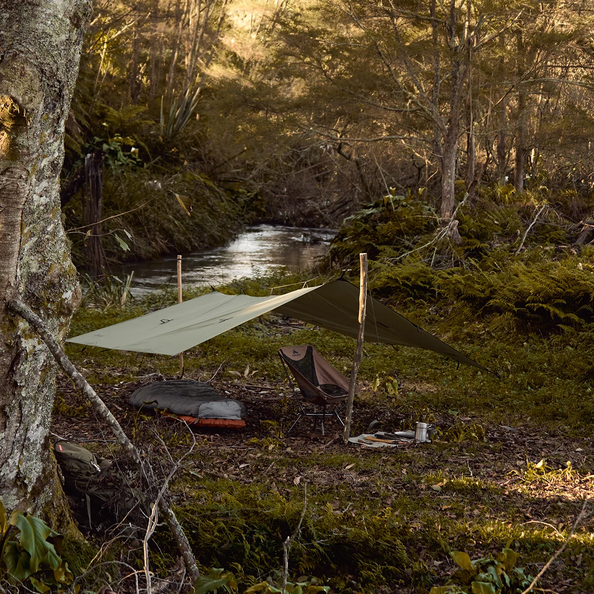 The Falko ultralight camping tarp set up net to mountain stream